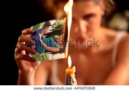 Broken heart woman. Couple break up. Sad bride on unhappy wedding. Woman and groom quarrel. Girl with vengeful look burns in fire candle family pictures. Portrait crying female.