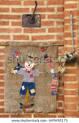 Handmade banner decoration of Juninas Party, a traditional celebration in Brazil. Cute straw man banner over a brick wall.