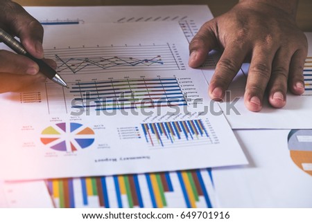 hand man doing finance. Reflection light and flare. Concept image of data gathering and statistical working.
