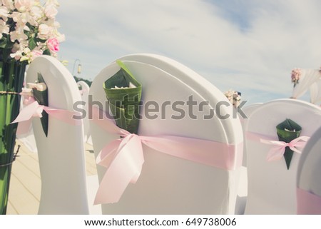 Floral arrangement at a wedding ceremony on the beach. (focus on flower and vintage colour picture style)