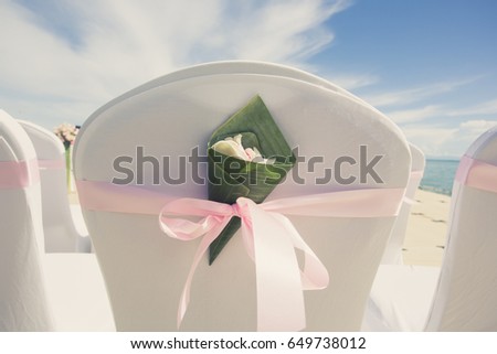 Floral arrangement at a wedding ceremony on the beach. (focus on flower and vintage colour picture style)