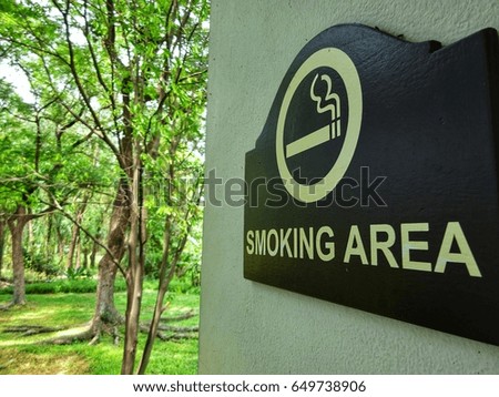 Smoking area badge near by green forest. 