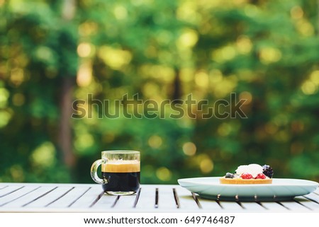 Desserts and coffee outside with a forest background