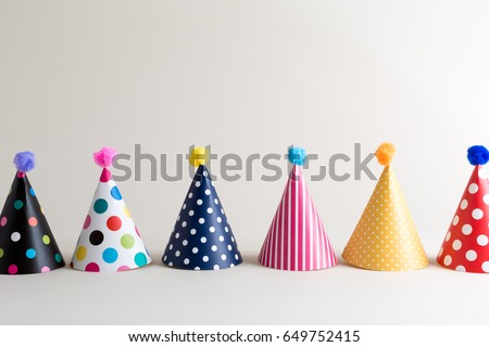 Party theme with with hats on an off white background Royalty-Free Stock Photo #649752415