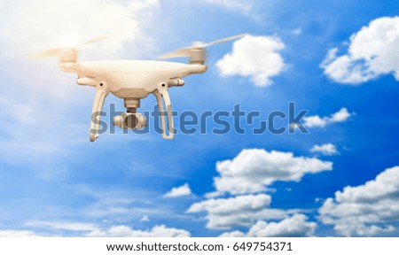 Flying drone with stabilizer camera outdoor on the sky.