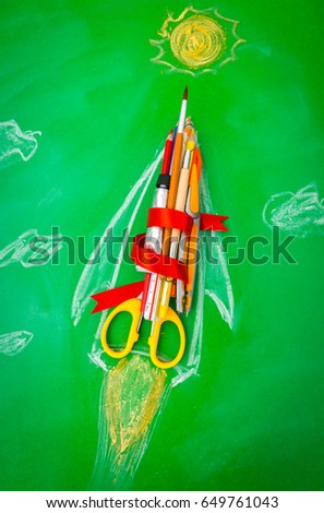 Rocket made from School supplies on Green chalkboard " Back to school background "