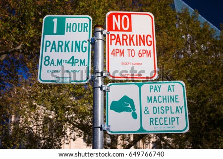 Three parking signs on one pole in Sacramento, California