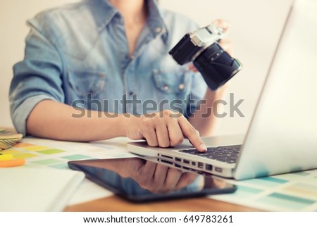 Photography Ideas Creative Occupation Design Studio Concept, Female photographer sitting on the desk with laptop.