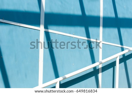 Texture, background, pattern. The landscape is upbanish. Lines of shadows, blue background, white lines