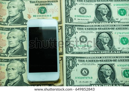 Mobile smartphone on US dollar banknote, digital money concept