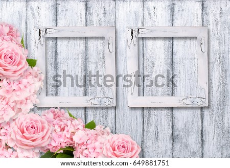 Wooden background and photo frames with roses and hortensia in rustic style