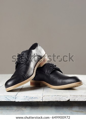 classic men's shoes.fashion still life men boots on wooden table