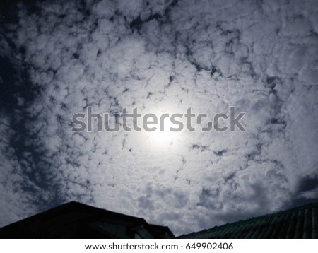 Moonlight, the night sky with a lot of clouds.