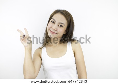 Show victory sign with happy smiling face, pose by lifestyle of asian beautiful woman portrait in casual dress looking front, standing and thinking positive in grey background.