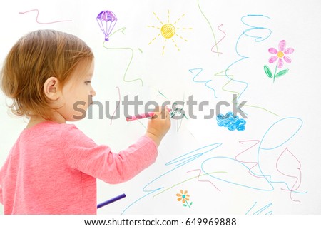 Art concept. Cute little girl drawing on white background with space for design