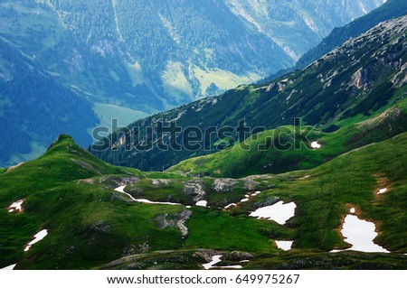 Detail of mountain landscape. Beautiful spring view at Grossglockner High Alpine Road Hochtor Pass. Green valley with snow. Highest mountain pass road in Austria.