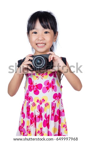 Asian Little Chinese girl holding a camera in isolated white background