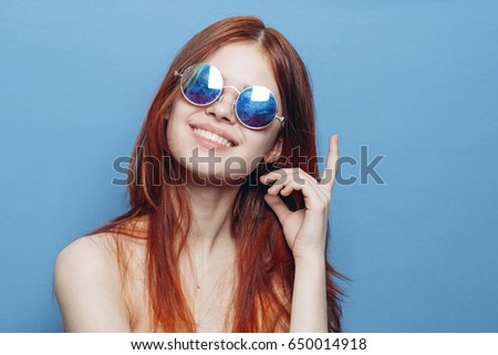 Woman in glasses on a blue background