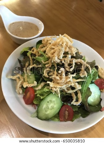 Salad with deep fried silver fish and sesame dressing