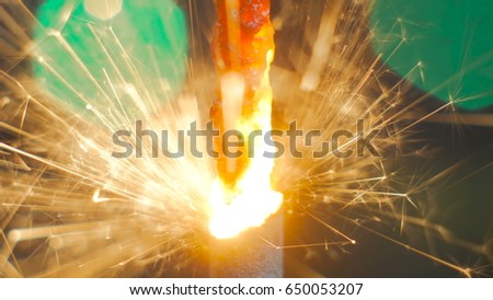 Firework sparkler burning. Elegant abstract garlands bokeh background. Extreme macro shot. Christmas and New Year concept