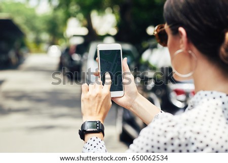 Close-up image of woman examining map in her navigation mobile application