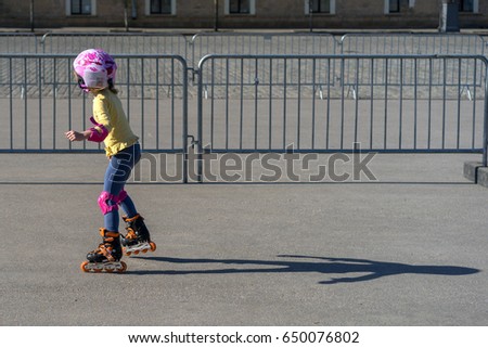Girl riding on asphalt roller