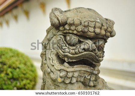 Stone Lion Chinese Statue in the Temple , Bangkok , Thailand