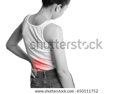rear view of a young women holding her back in pain. isolated on white background. monochrome photo with red as a symbol for the hardening.