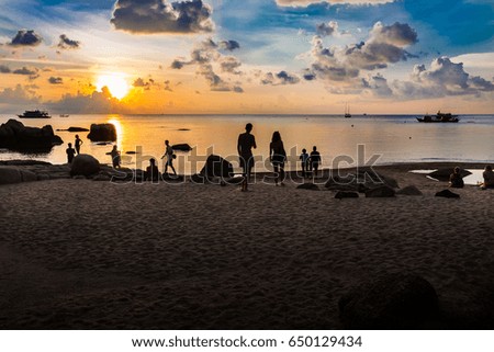 Silhouette tone: Sunset view at the beautiful beach with people 