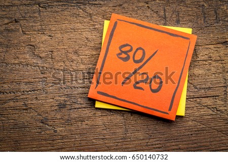 Pareto principle or eighty-twenty rule represented on a sticky note against rustic wood - a reminder or advice Royalty-Free Stock Photo #650140732