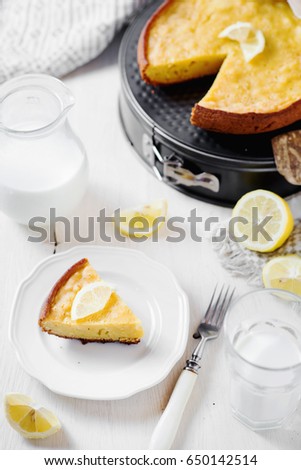 Desserts and pastries, sweet food, lemon biscuit pie with milk on a light wooden background 