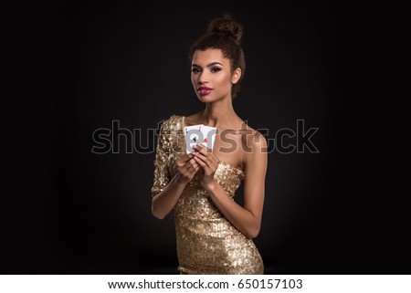Pretty african girl shows two aces in casino poker and win 