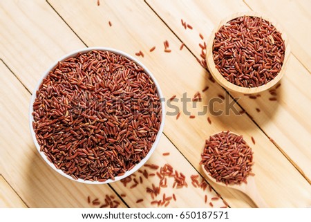 Rice berry in white bowl on wooden background, Rice berry from asia