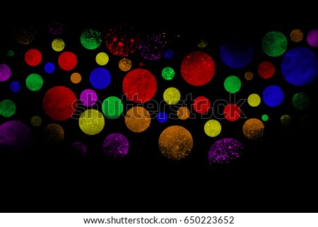 Multicolor powder explosion on black background.