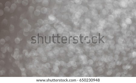 Fresh flower wrapping paper or fabric gift wrapping paper is not focus. Abstract background with bokeh. White bokeh lights on gray background.