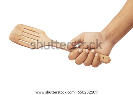 Hand holding Kitchen Wood Spatula isolated on white background.