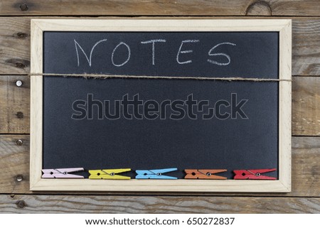Space chalkboard background texture with wooden frame with the word "Notes". blackboard space for wallpaper. Landscape mounting style horizontal.

