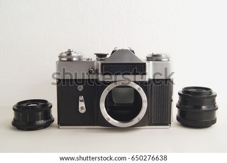 Old Soviet film camera with lens on white background close-up.