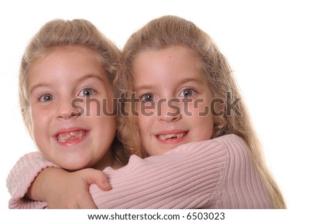 happy sisters hug on white