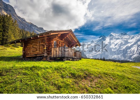Wooden Swiss chalet in Swiss Alps near Kandersteg and Oeschinnensee, Canton Bern, Switzerland, Europe. Royalty-Free Stock Photo #650332861
