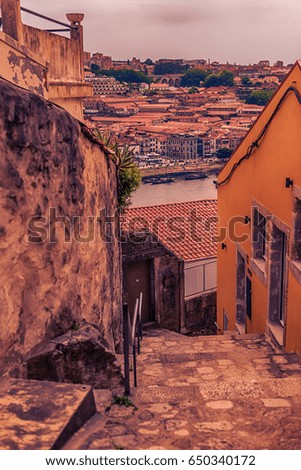 Porto, Portugal: traditional narrow street in the old town, the Vila Nova de Gaia side and Douro river
