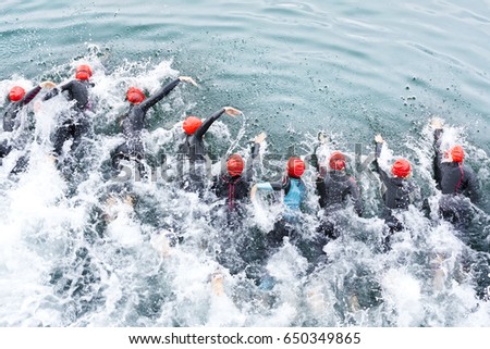  triathlon competitors in swim , triathletes in action and motion Royalty-Free Stock Photo #650349865