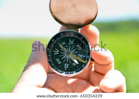 Compass in hand. A navigation tool for off-road orientation.
