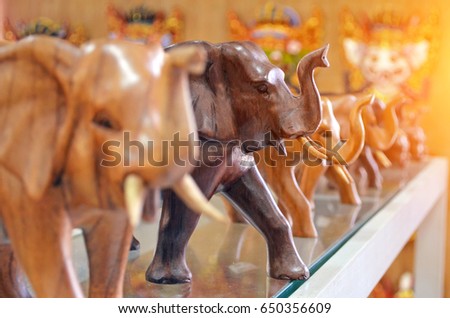 Wooden elephant figurines lined up in a row.