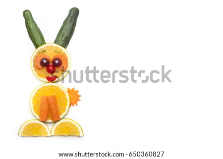Food art creative concepts. Cute bunny rabbit made of fruits and vegetables, such as orange, cucumber and carrots isolated on a white background