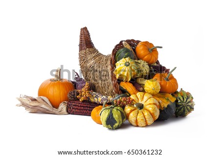 Thanksgiving festive cornucopia horn of plenty filled with autumn fruits and vegetables; isolated on white background  Royalty-Free Stock Photo #650361232