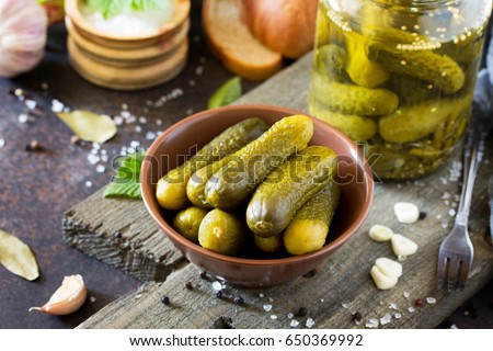 Marinated cucumbers gherkins. Pickles with mustard and garlic on a stone background. Royalty-Free Stock Photo #650369992