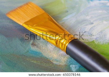 Brush on a colored background, painted oil