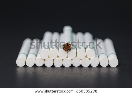 Cigarettes with a soft focus background is dark.