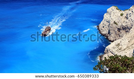 Pirate style boat ship in the ionian sea blue water, near famous Navagio beach, on  Zakynthos island, Greece